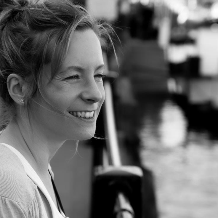 Avery Chen, Lead Design Curator at Sunlit Thread Haven, reviewing corporate floral arrangements